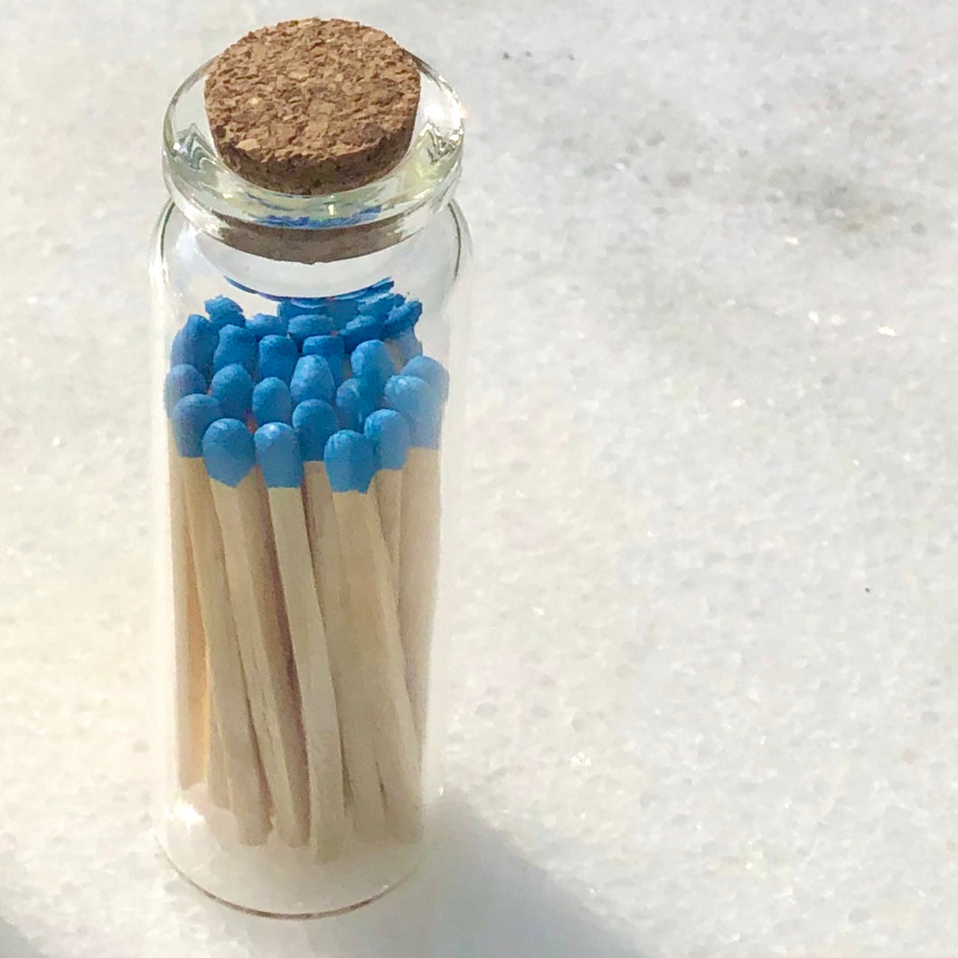 Matches in a glass bottle with a cork.